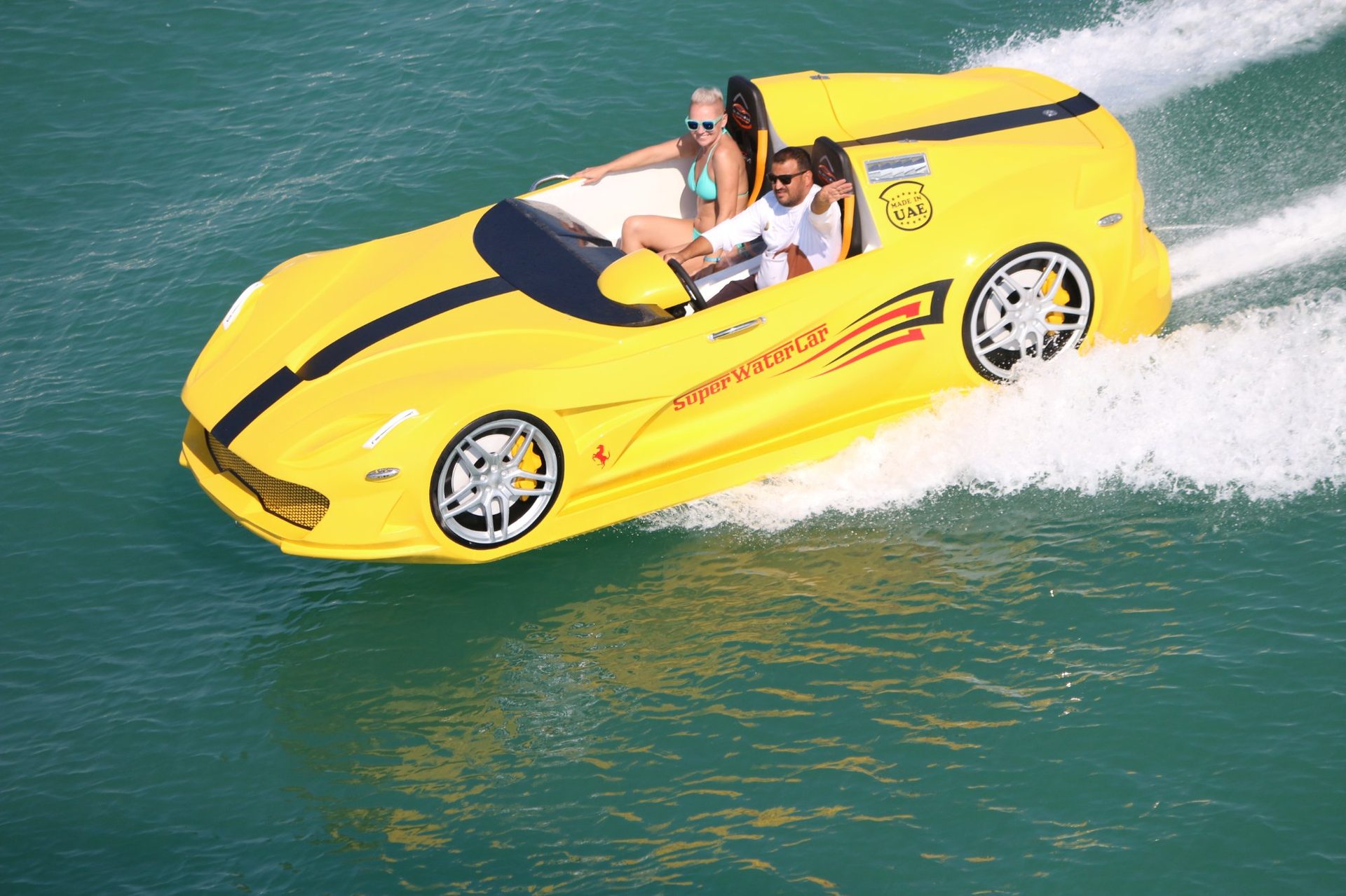 Super Water Car red and yellow jet car watercraft racing on calm UAE marina waters