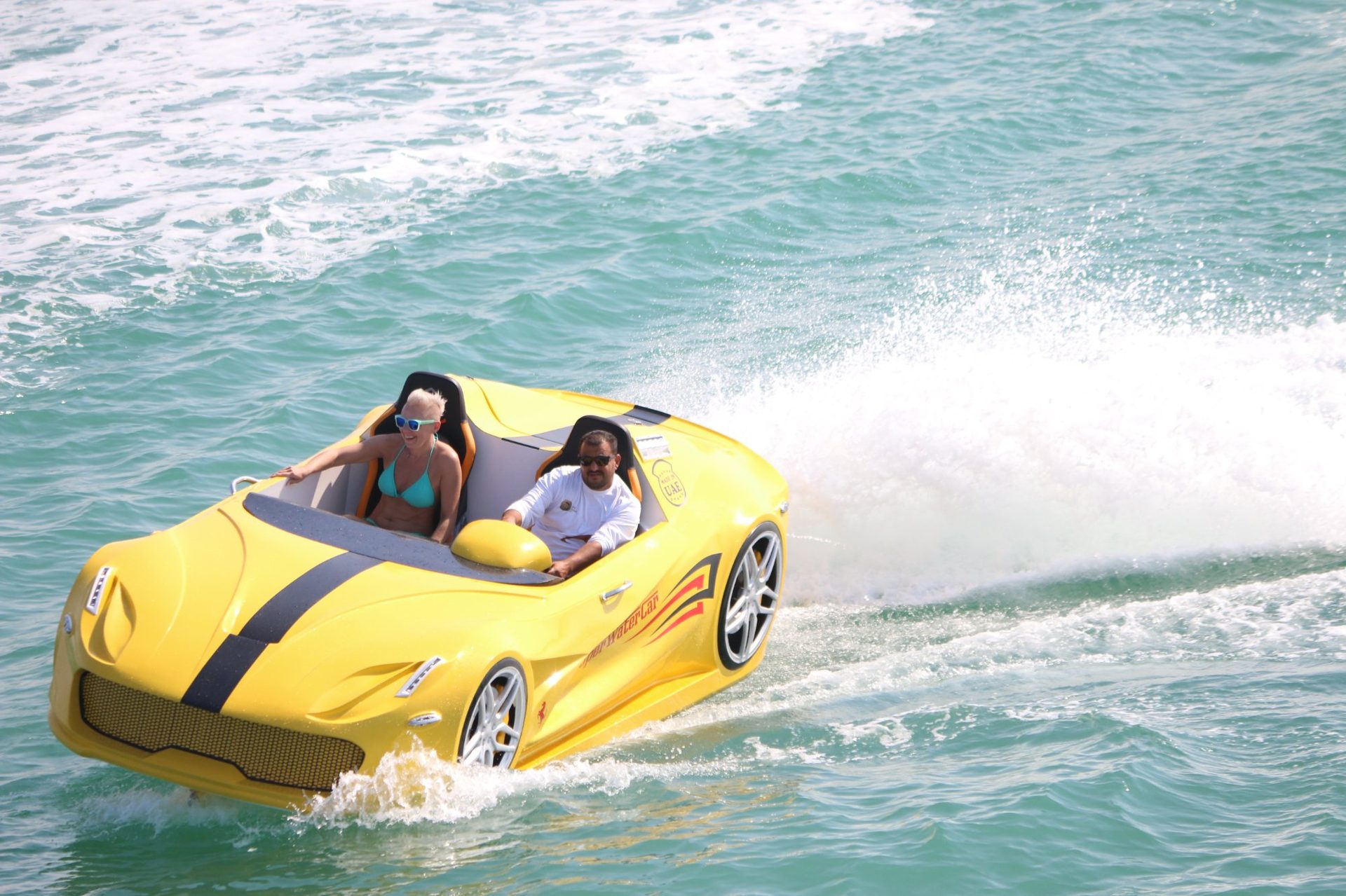 Red Super Water Car aerial top-down view with riders enjoying luxury water sports UAE